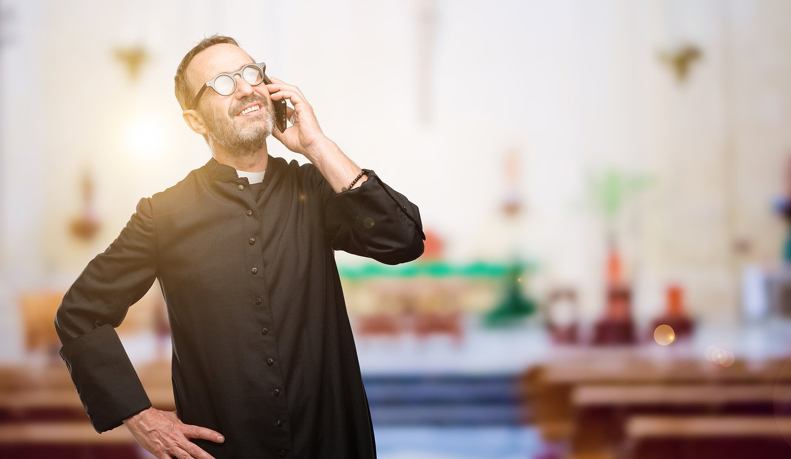 bigstock-Priest-religion-man-happy-talk-238560127