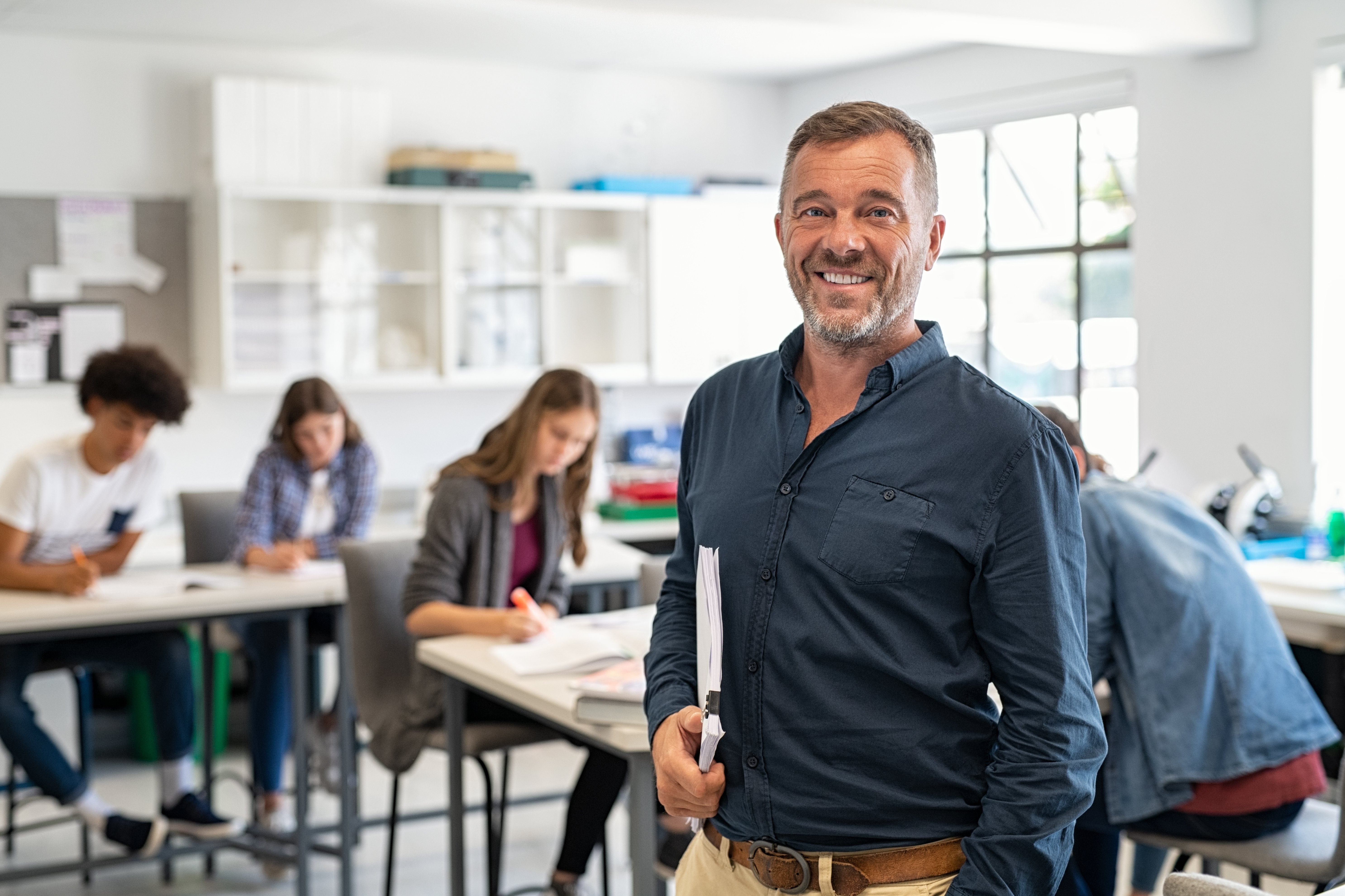 bigstock-Portrait-of-mature-teacher-loo-395337539